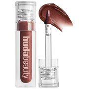 HUDA BEAUTY  Faux Filler Shiny Non-Sticky Lip Gloss-Color: She Fire - a sheer deep brown gloss