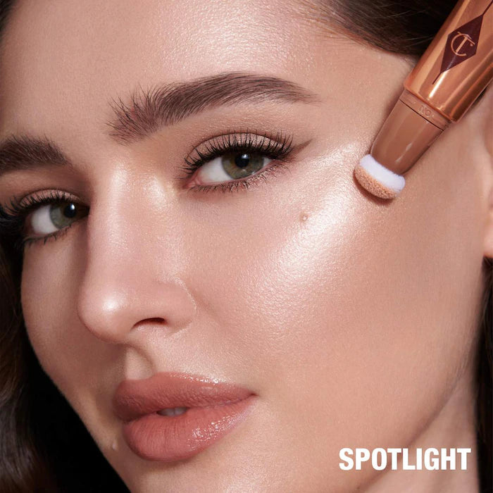 Charlotte Tilbury 
Beauty Highlighter Wand. Color: Spotlight - rose gold with silver light